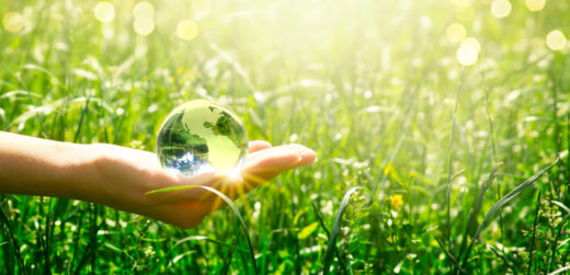 Glass globe in one hand