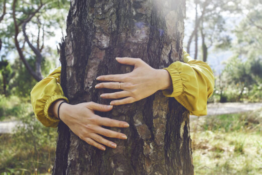 Woman hugs a tree